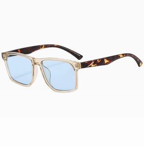 Close-up of champagne square frames with blue lenses and tortoiseshell temples
