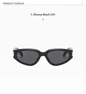 Detail of trendy black cat-eye sunglasses with dark lenses and silver metal hinges