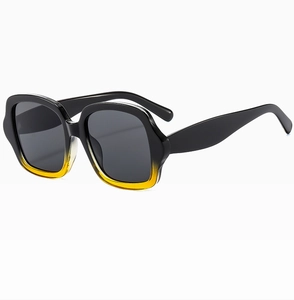 Détail des lunettes de soleil carrées vintage avec monture épaisse dégradé noir et jaune