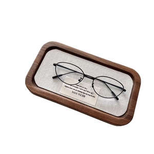 Kids vintage oval cat-eye sunglasses with thin black frame on a wooden display tray