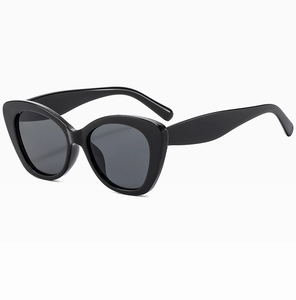 Close-up of elegant purple cat eye sunglasses featuring thick black frames and dark lenses