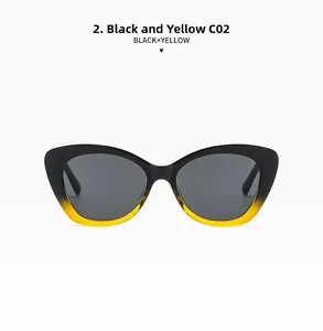 Detail of cat-eye sunglasses featuring a stylish black and yellow gradient frame and lenses