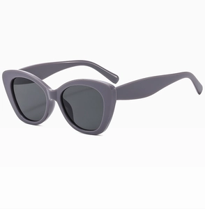 Detail view of purple cat eye sunglasses with thick frames and dark lenses