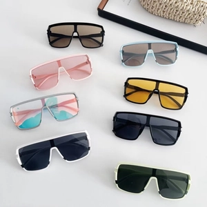 Flat lay of trendy oversized wrap-around sunglasses for kids in diverse vibrant colors