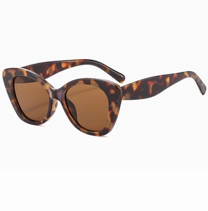 Detail of cat-eye sunglasses with classic tortoiseshell frame and dark brown lenses