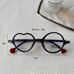 Detail of kids' asymmetric blue light glasses with heart and circle frames on white background