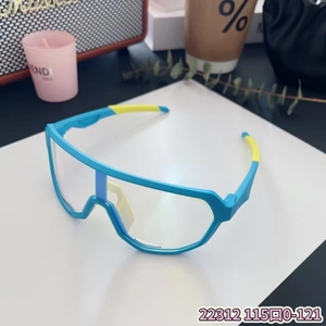Detail view of blue and yellow kids sports cycling goggles with wrap-around lenses