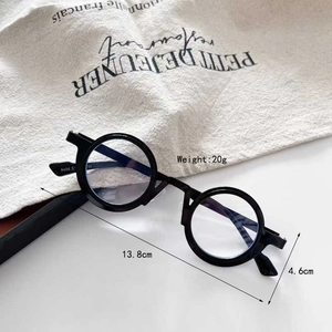 Macro view of matte black round frame steampunk glasses with temple size markings