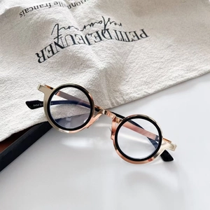 Detail view of steampunk round metal glasses frame with rose gold and black finish