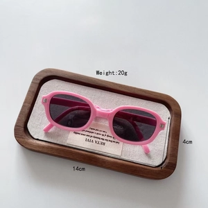 Pink rectangular kids sunglasses shown in wooden tray with dimension details
