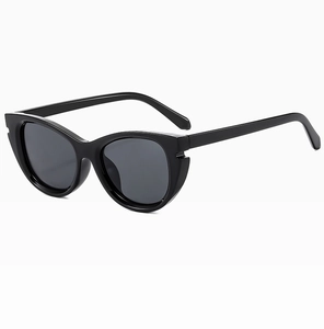 Detailed close-up of glossy black retro cat-eye sunglasses with dark grey lenses