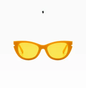 Close-up of stylish orange cat-eye sunglasses with yellow transparent lenses and sleek frame