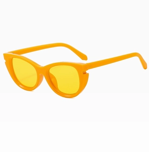 Close-up of retro cat-eye sunglasses with bright orange frames and yellow lenses