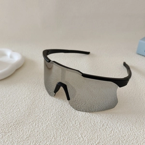 Detail of silver mirrored lens and matte black frame on cycling sports sunglasses