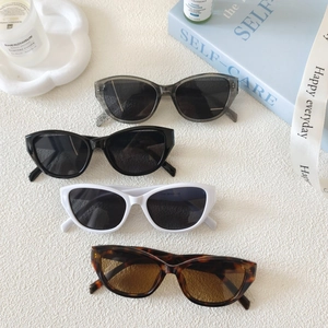 Retro cat-eye sunglasses for women in four assorted colors shown on an elegant prop display