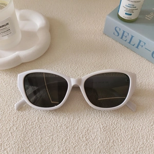 Macro shot of white chunky frame sunglasses temple with printed model specifications