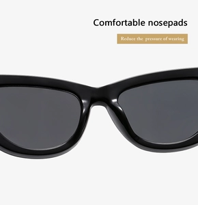 Detail of ergonomic one-piece nose pads on black cat-eye sunglasses for comfort