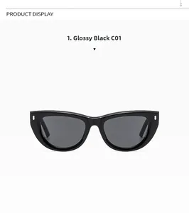 Close-up of bright black cat eye sunglasses with silver rivets and smoke gray lenses