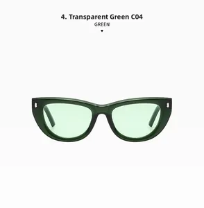 Close-up of transparent green cat eye sunglasses with metal rice studs and green lenses