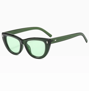 Detail of green cat-eye sunglasses featuring silver stud accents and inner temple markings