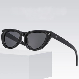 Elegant cat eye sunglasses in glossy black frame with silver accent on gradient background