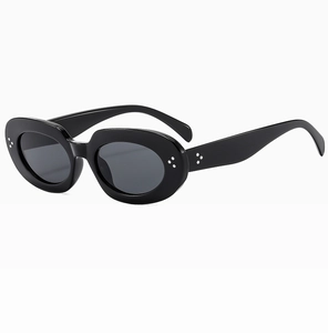 Detail of black oval sunglasses featuring silver rivets and high-gloss resin finish