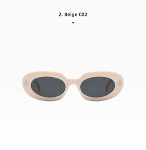 Detailed view of beige oval sunglasses featuring decorative metal rivets and dark lenses
