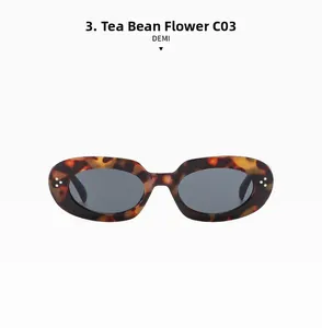 Close-up of retro oval tortoiseshell sunglasses with three white rivets and grey lenses