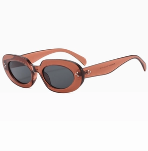 Close-up of vintage oval tea sunglasses featuring silver rivet accents and ZN3880 stamp