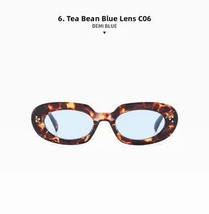 Detail of demi blue oval sunglasses featuring metallic rivets and light blue lenses