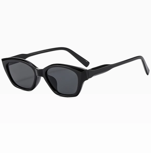 Detail view of glossy black cat-eye sunglasses with integrated nose pads and sleek frames