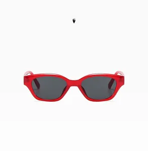 Detailed close-up of chunky red cat-eye sunglasses with dark grey UV lenses