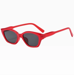 Detail view of red cat-eye sunglasses with dark lenses and durable frame structure
