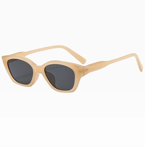 Detail view of vintage cat-eye sunglasses with sand beige matte frame and dark grey lenses