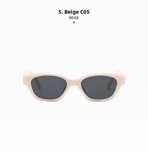 Macro detail of beige cat-eye sunglasses with thick frame and dark tinted lenses
