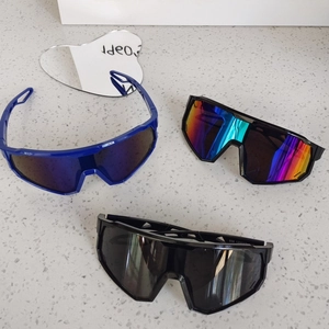 Close-up of kids' cycling sunglasses in blue, black and rainbow gradient lenses