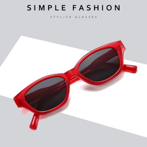 Fashionable red transparent cat eye sunglasses on a minimalist geometric pedestal