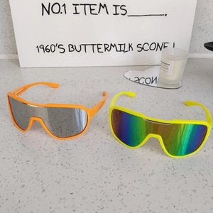 Close-up of bright orange and neon yellow kids outdoor sports cycling sunglasses