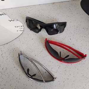 Kids aerodynamic sports sunglasses in black, red, and silver with UV protection lenses