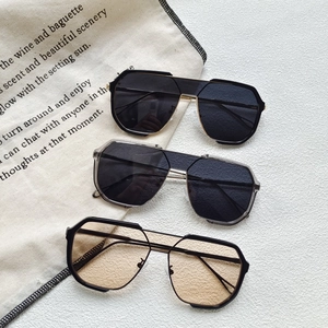 Three pairs of oversized polygonal sunglasses in black and transparent grey with gold double bridge