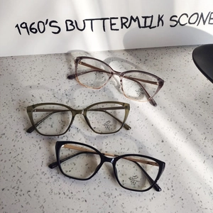 Cat eye anti-blue light glasses in black, olive and gradient colors on a stone surface
