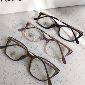 Detailed view of cat-eye glasses with golden textured metal temples and blue light blocking