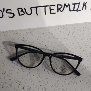 Macro shot of black cat-eye glasses with UV400 and anti-blue light lens marking