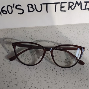 Detail view of cat eye glasses with anti-blue light and UV 400 lens protection stickers