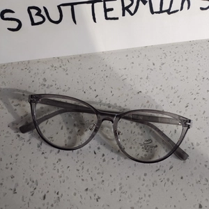 Detail view of transparent grey oval frames with anti-blue light and UV400 lenses