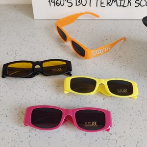 Detailed close-up of colorful UV400 rectangular kids sunglasses with CE certification labels