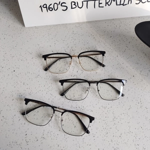 Three retro semi-rimless browline glasses with blue light protection on terrazzo surface