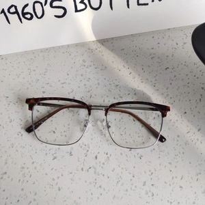 Detailed macro view of vintage semi-rimless glasses with tortoiseshell and silver metal frame