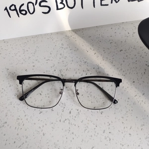 Detail view of half-rim browline glasses showing the silver metal frame and nose pads