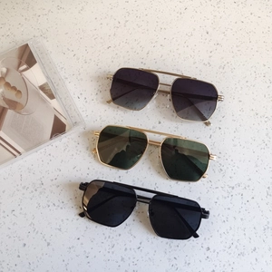 Detailed top view of geometric pilot sunglasses in gold and matte black metal frames